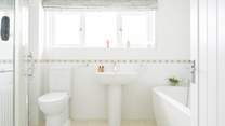The ground floor family bathroom with roll top bath and a shower cubicle.