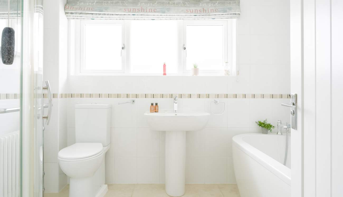 The ground floor family bathroom with roll top bath and a shower cubicle.