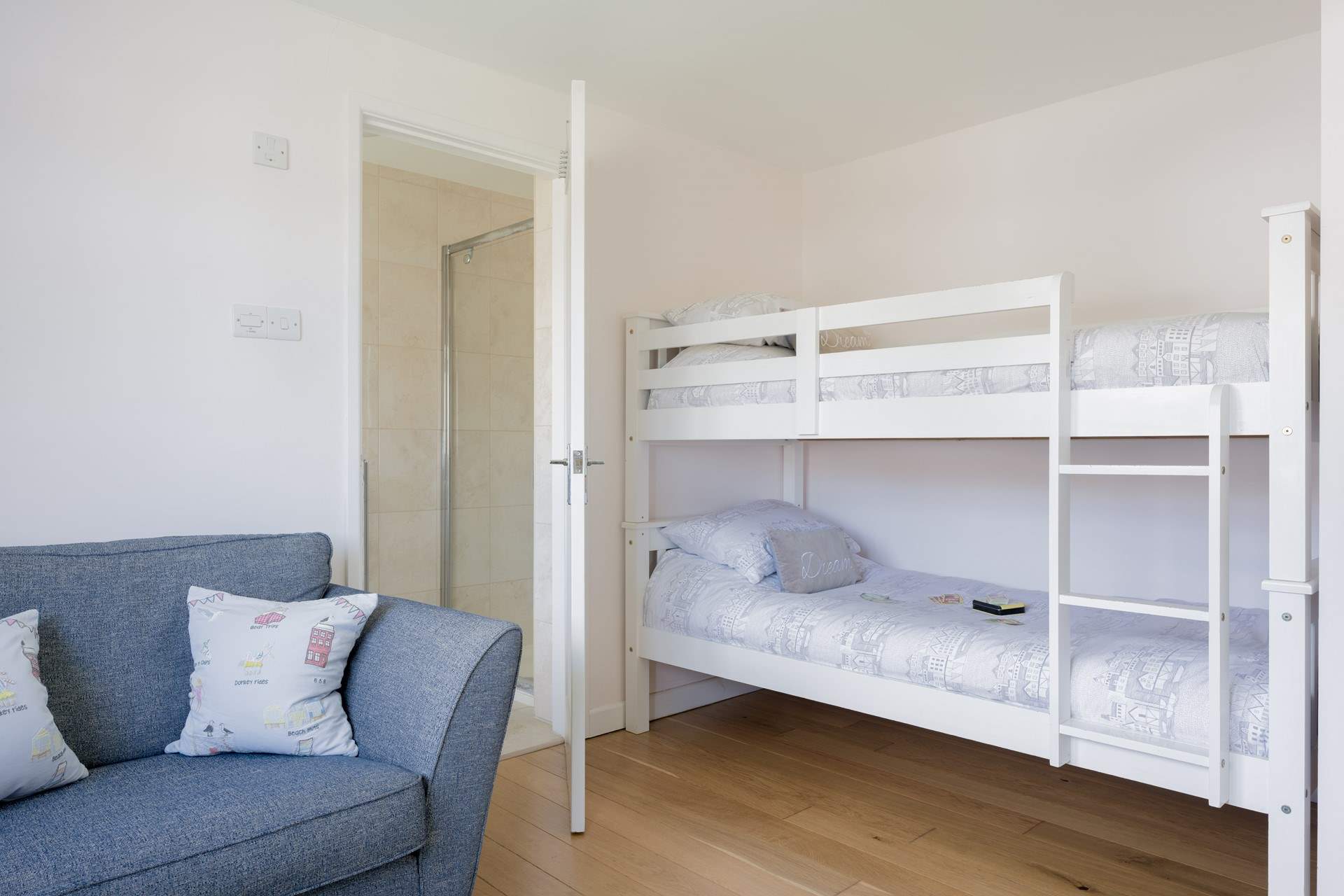 The spacious bunk bedroom offers an en suite shower-room. 