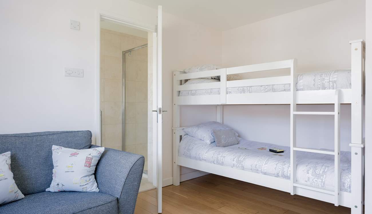 The spacious bunk bedroom offers an en suite shower-room. 