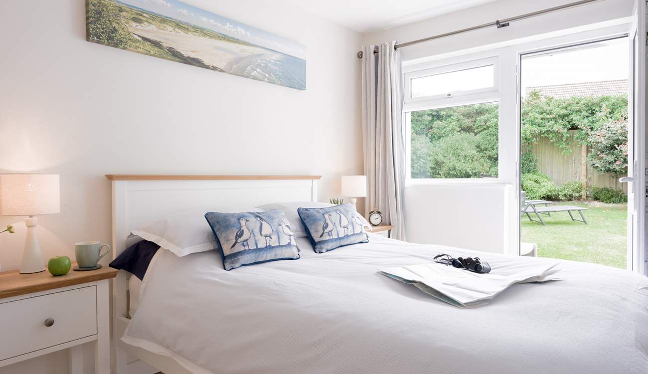 Bedroom 2 offers the perfect spot to relax and recharge with a door out to the back garden.