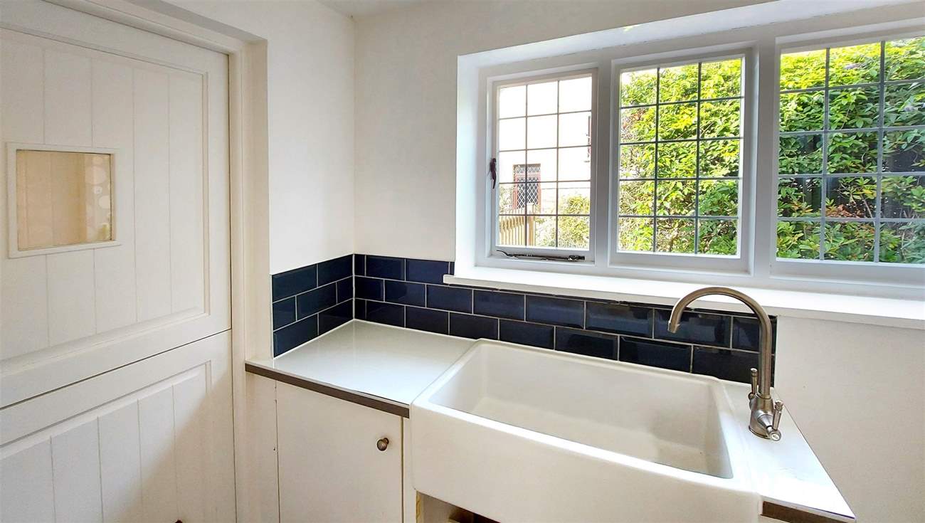 The utility-room has a drinks fridge, washing machine and tumble-drier.