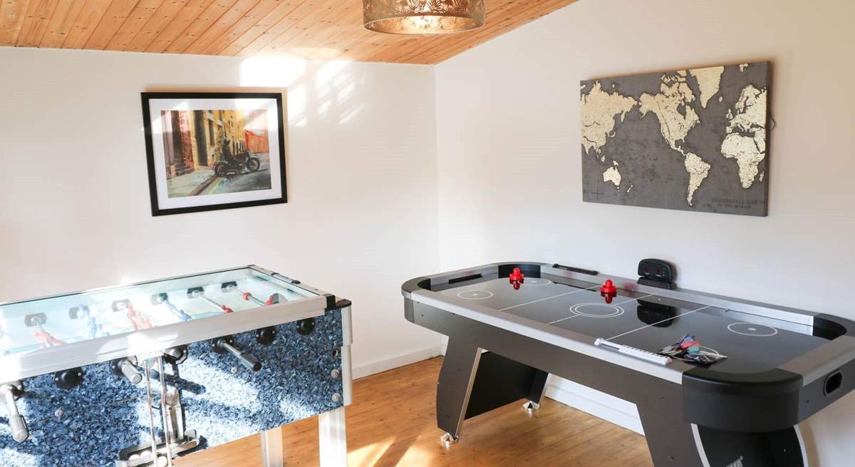 The games-room is at the bottom of the garden with an air hockey table, table football and retro arcade games machine.