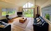 The delightful sitting-room has a warming wood-burner to keep you cosy throughout the seasons.  - Thumbnail Image