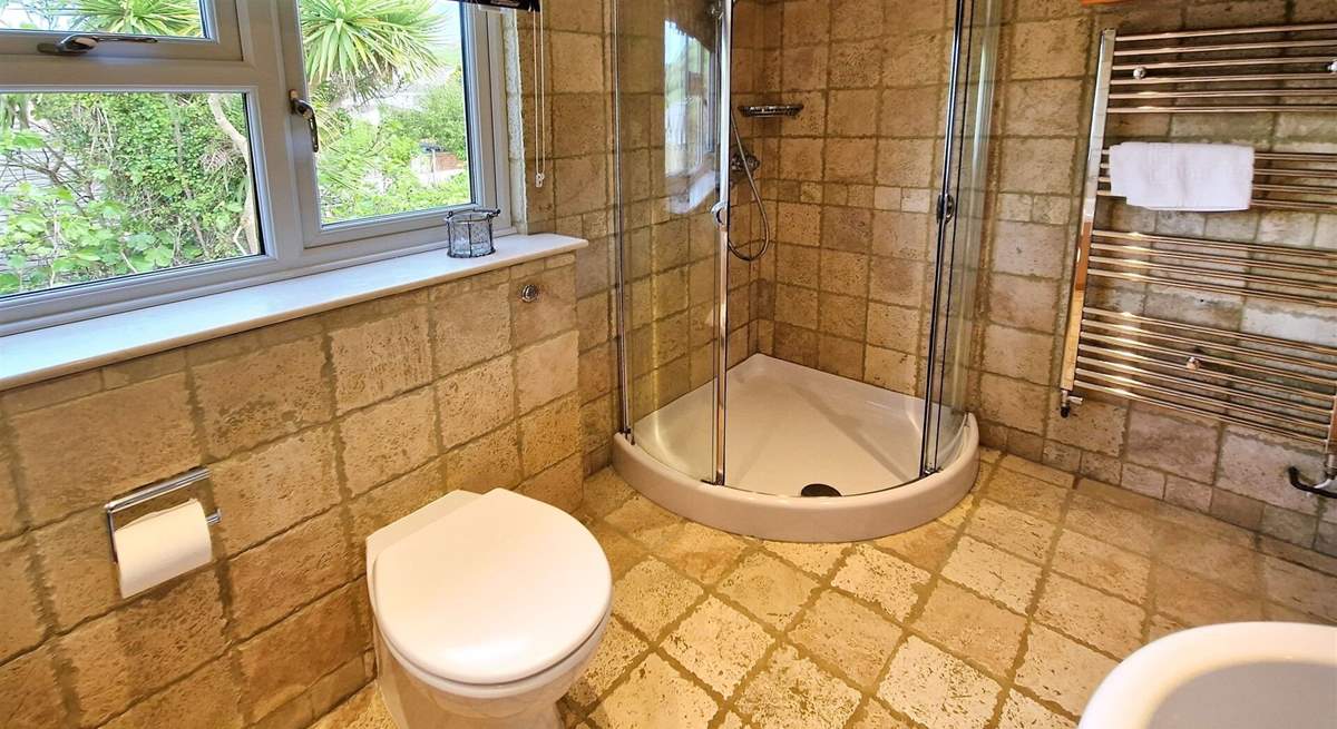 The bathroom has a separate shower and bath. 
