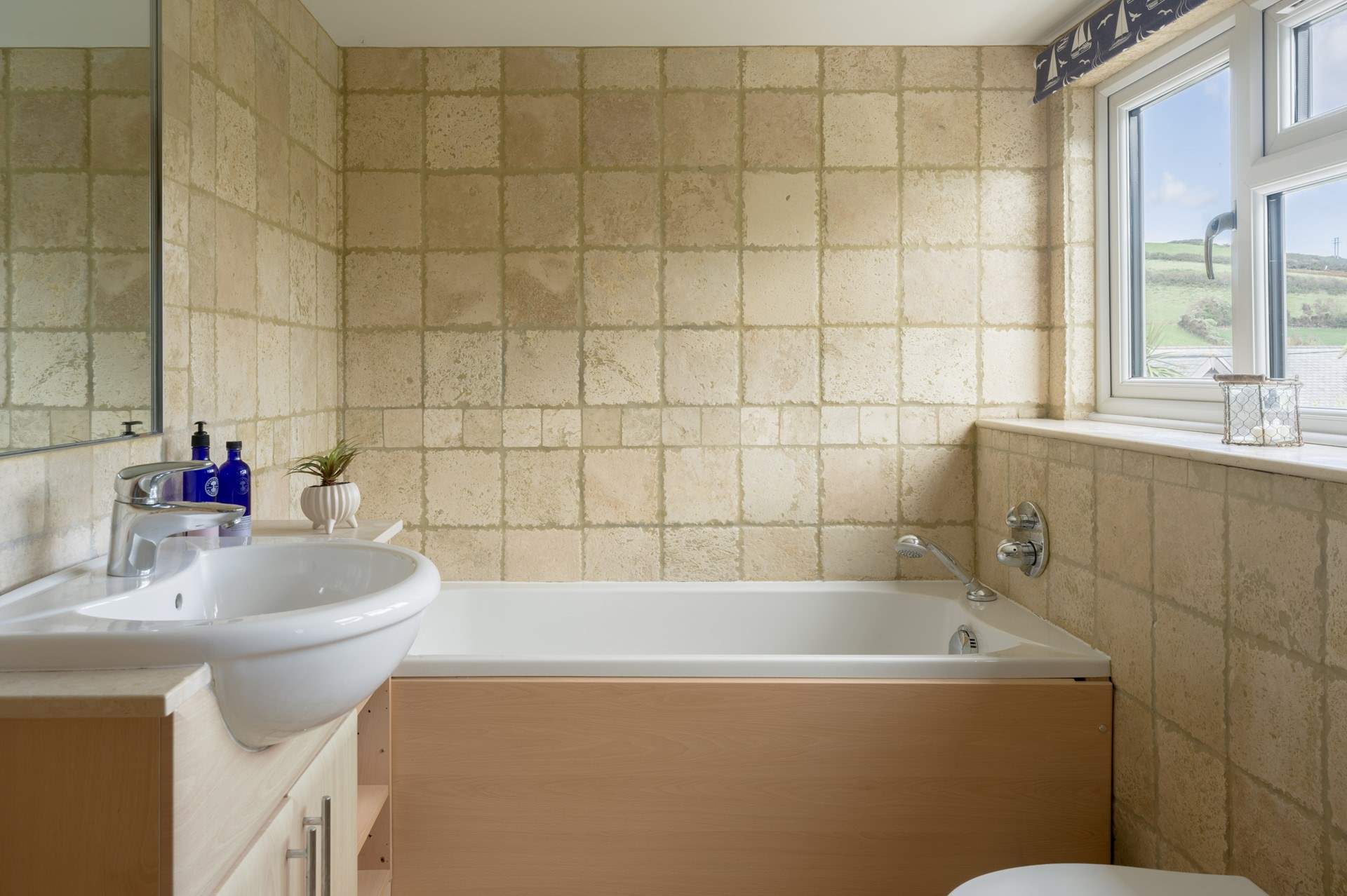 The bathroom has a separate shower and bath. 