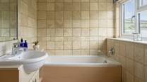 The bathroom has a separate shower and bath. 