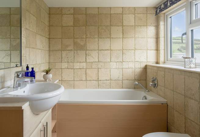 The bathroom has a separate shower and bath. 