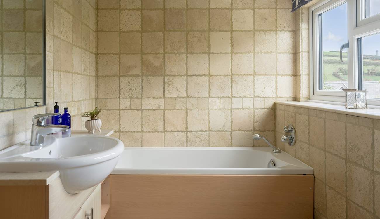 The bathroom has a separate shower and bath. 