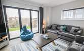 Patio doors lead into the garden from the stylish sitting-room.  - Thumbnail Image