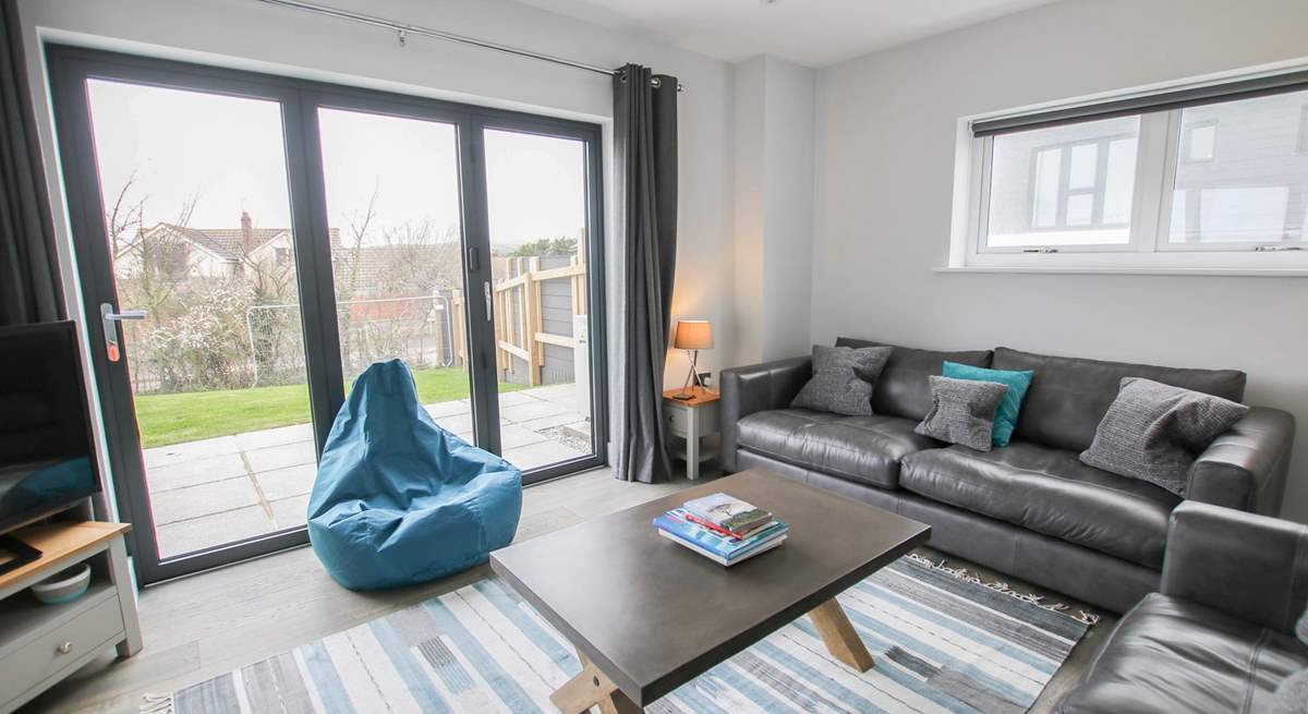 Patio doors lead into the garden from the stylish sitting-room. 