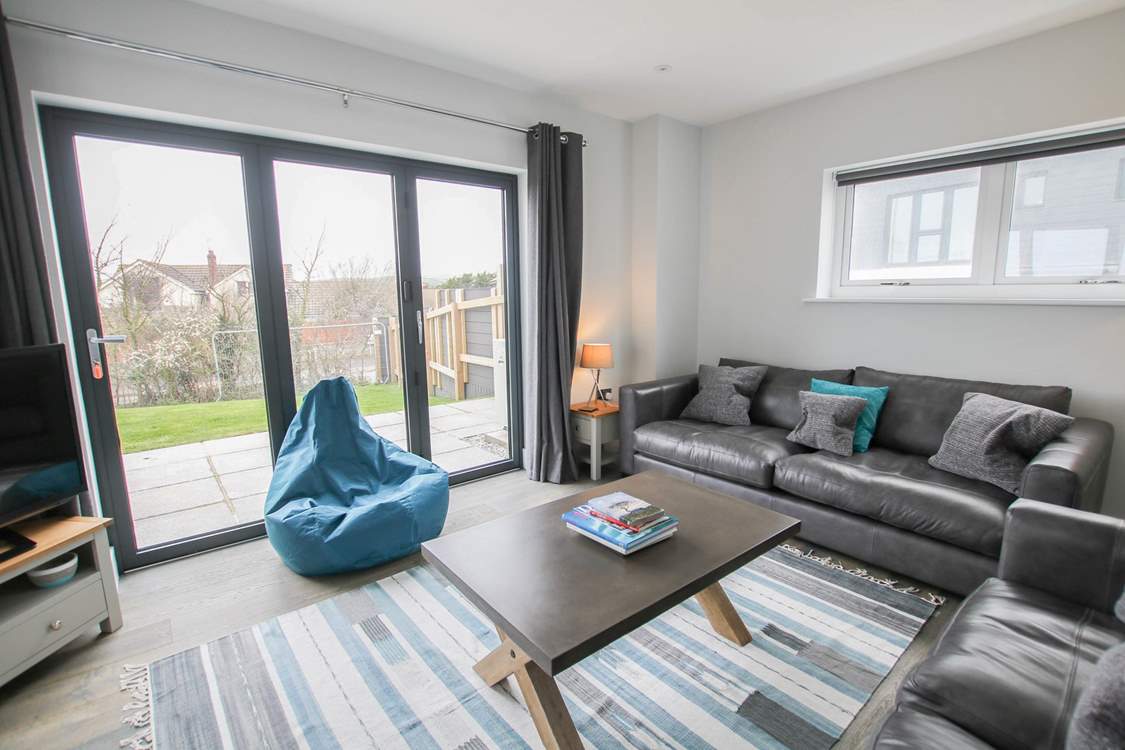 Patio doors lead into the garden from the stylish sitting-room.