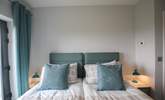 The beds are adorned with lovely linens. - Thumbnail Image