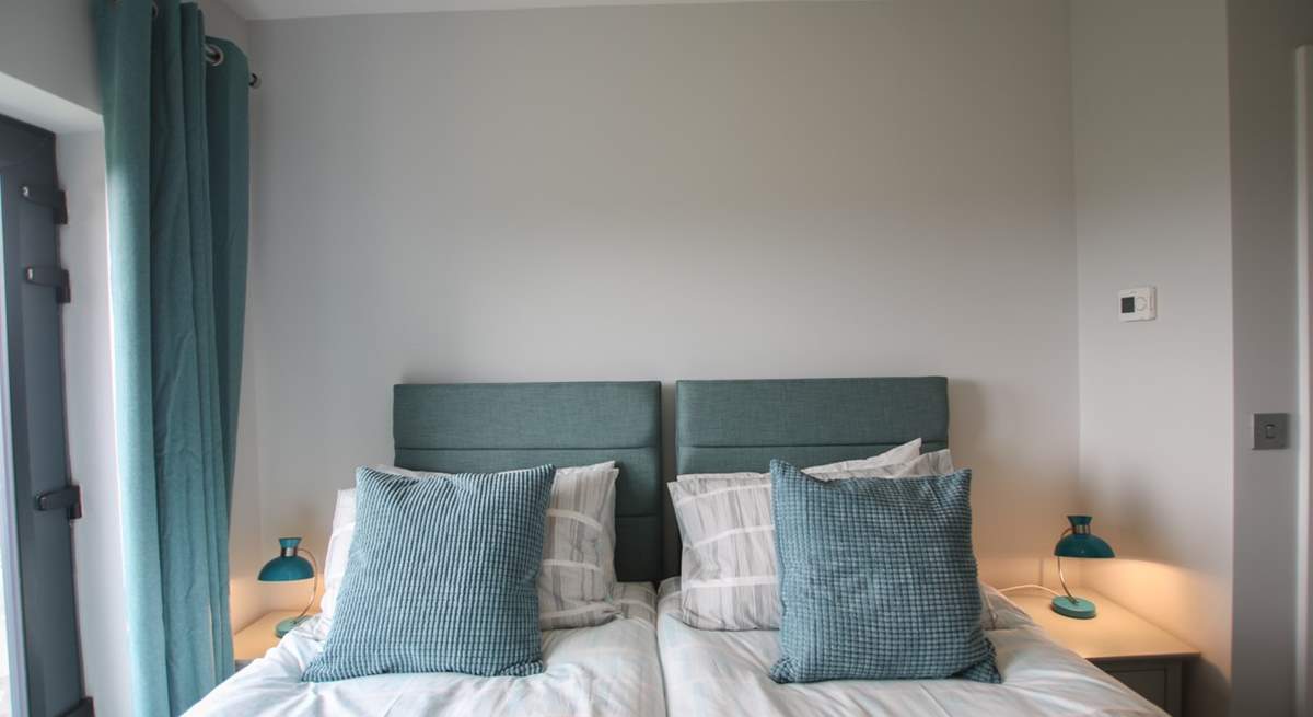 The beds are adorned with lovely linens.