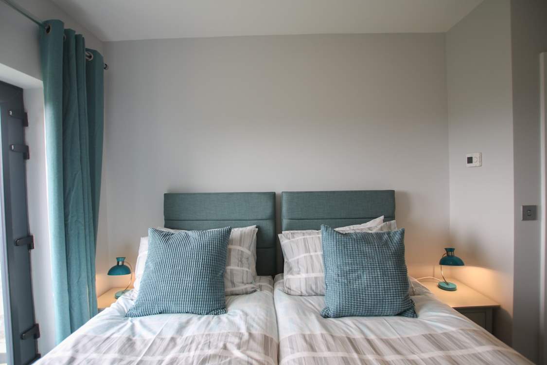 The beds are adorned with lovely linens.
