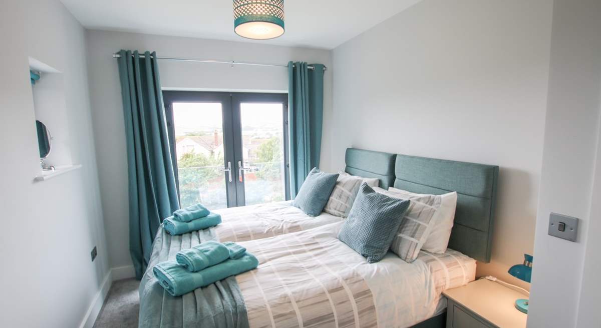 Bedroom 2 has a Juliet balcony facing towards the sea and can be made up as a twin or king-size double bed.