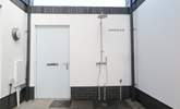 Surfers will delight in the outside hot/cold shower and hanging space for wetsuits plus there's plenty of space for storing the surf boards. - Thumbnail Image