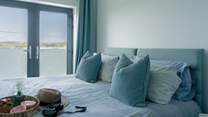 Bedroom 2 is a 'zip and link' and can be made up as a super-king or twin beds with a Juliet balcony facing towards the sea and an en suite shower-room.