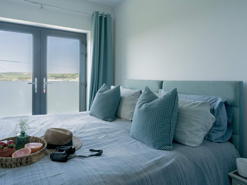 Bedroom 2 is a 'zip and link' and can be made up as a super-king or twin beds with a Juliet balcony facing towards the sea and an en suite shower-room.