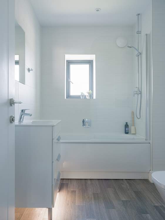 The family bathroom has a bath with shower over.