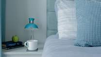 The beds are adorned with lovely linens.