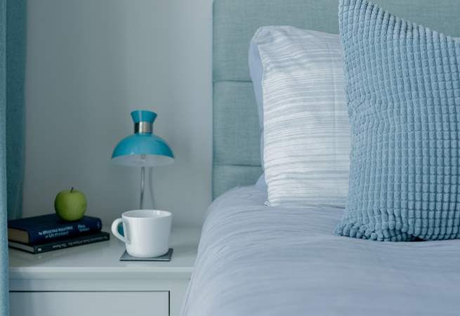 The beds are adorned with lovely linens.