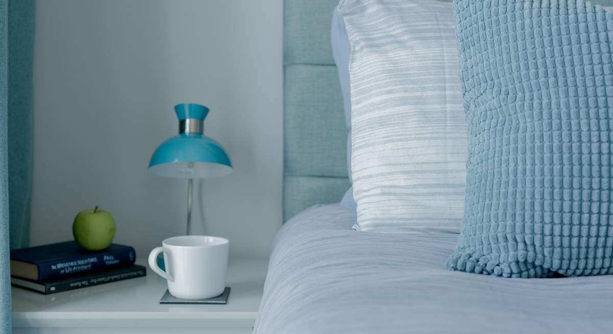 The beds are adorned with lovely linens.