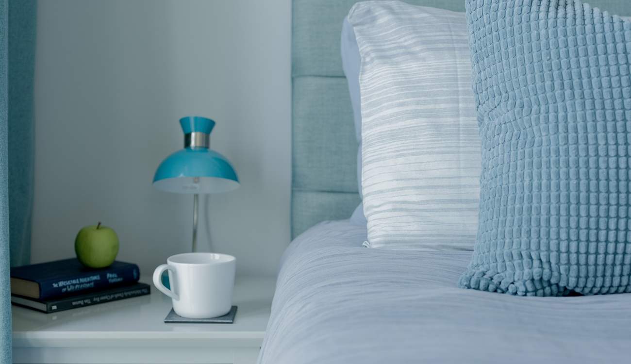 The beds are adorned with lovely linens.