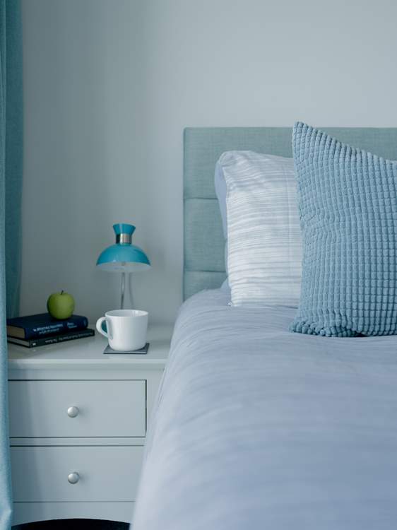 The beds are adorned with lovely linens.