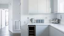 The sleek kitchen has everything you will need, including that all-important wine fridge!