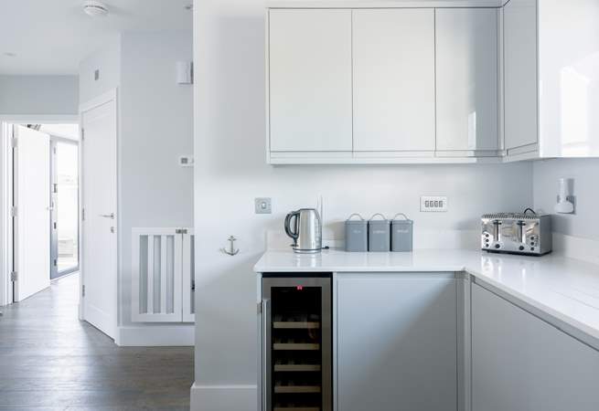 The sleek kitchen has everything you will need, including that all-important wine fridge!