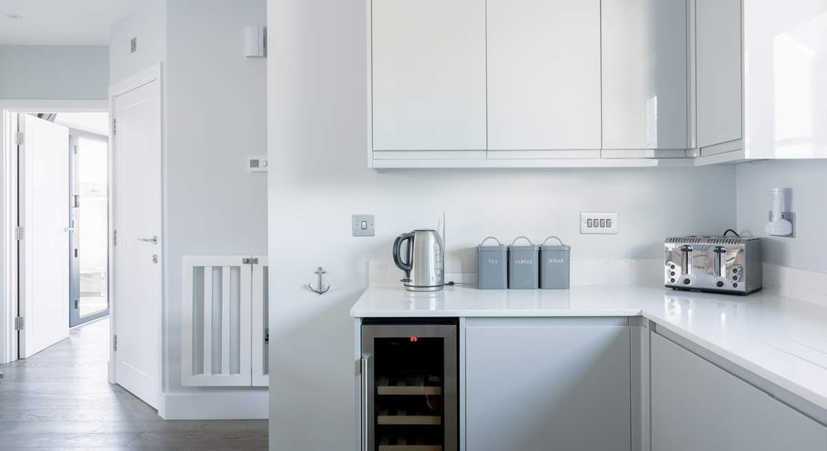 The sleek kitchen has everything you will need, including that all-important wine fridge!