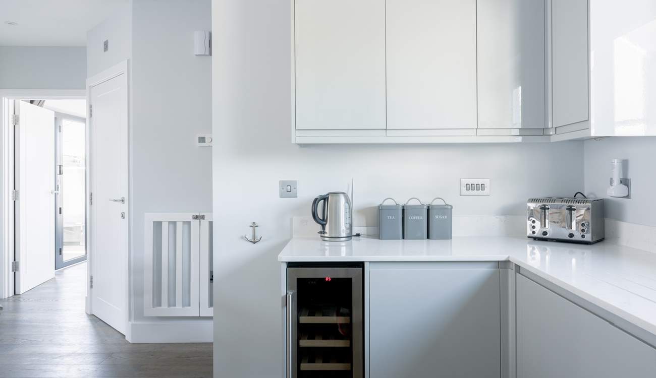 The sleek kitchen has everything you will need, including that all-important wine fridge!