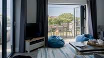 Open the patio doors  that lead into the garden from the stylish sitting-room. 