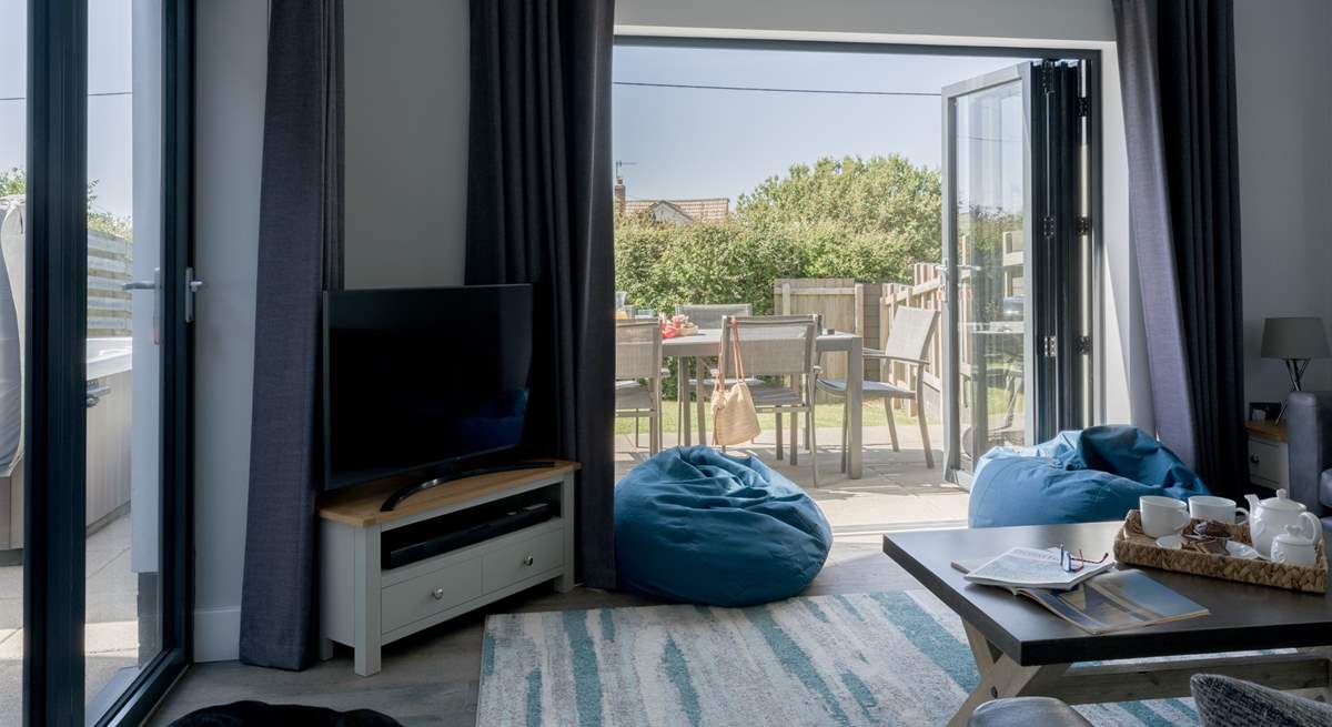 Patio doors lead into the garden from the stylish sitting-room. 