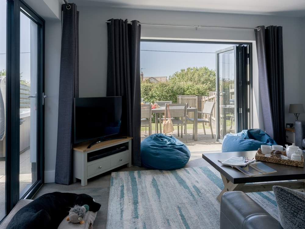 Patio doors lead into the garden from the stylish sitting-room.