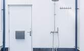 Surfers will delight in the outside hot/cold shower and hanging space for wetsuits plus there's plenty of space for storing the surf boards. - Thumbnail Image