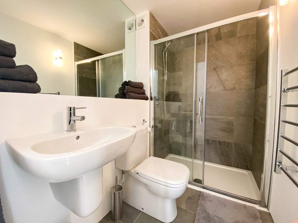 The family shower-room has a large shower cubicle.