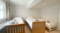 The twin bedroom has an additional day bed, suitable for children only. This room also has an en suite shower-room. 