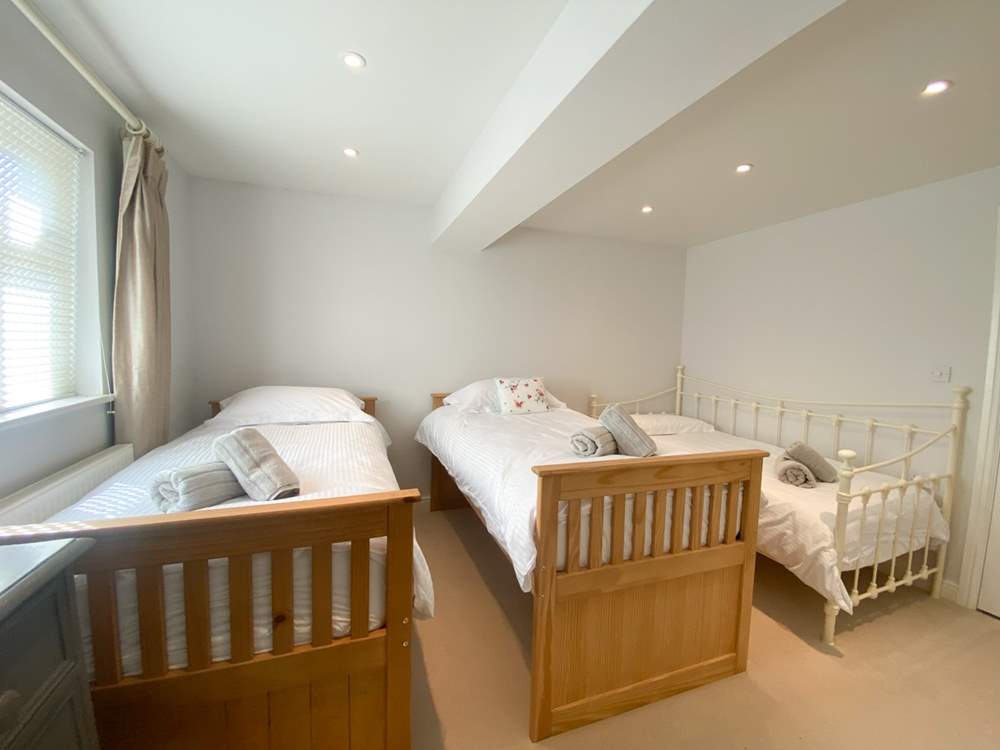 The twin bedroom has an additional day bed, suitable for children only. This room also has an en suite shower-room.