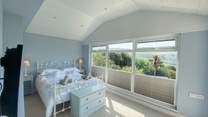 This pretty bedroom has delightful views. 