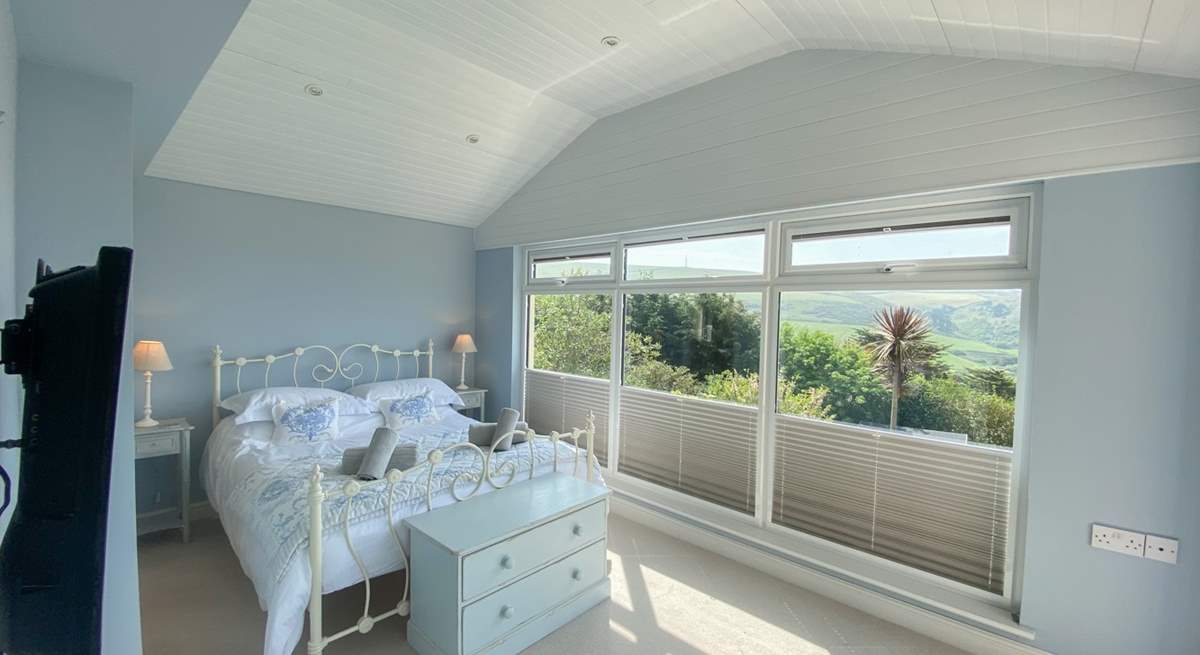 This pretty bedroom has delightful views. 