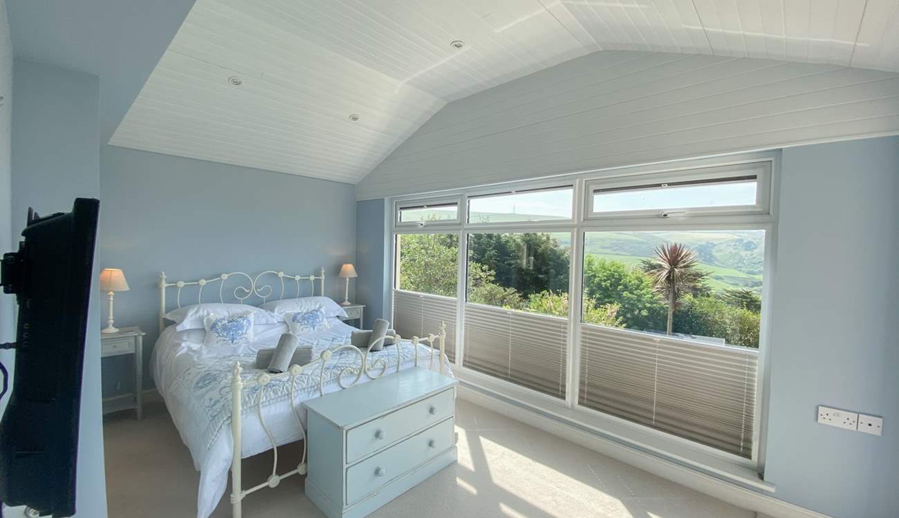 This pretty bedroom has delightful views. 