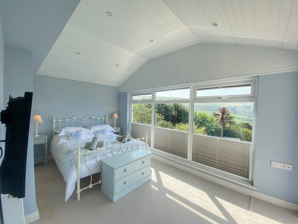 This pretty bedroom has delightful views.