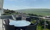 The gorgeous balcony has a table for al fresco dining. - Thumbnail Image