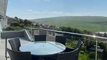 The gorgeous balcony has a table for al fresco dining.