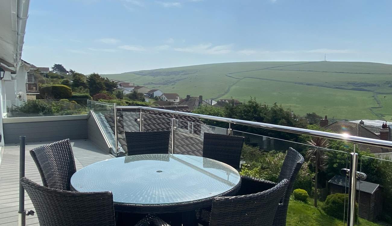 The gorgeous balcony has a table for al fresco dining.