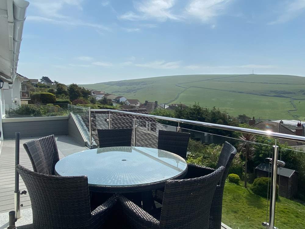The gorgeous balcony has a table for al fresco dining.