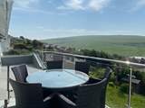 The gorgeous balcony has a table for al fresco dining.