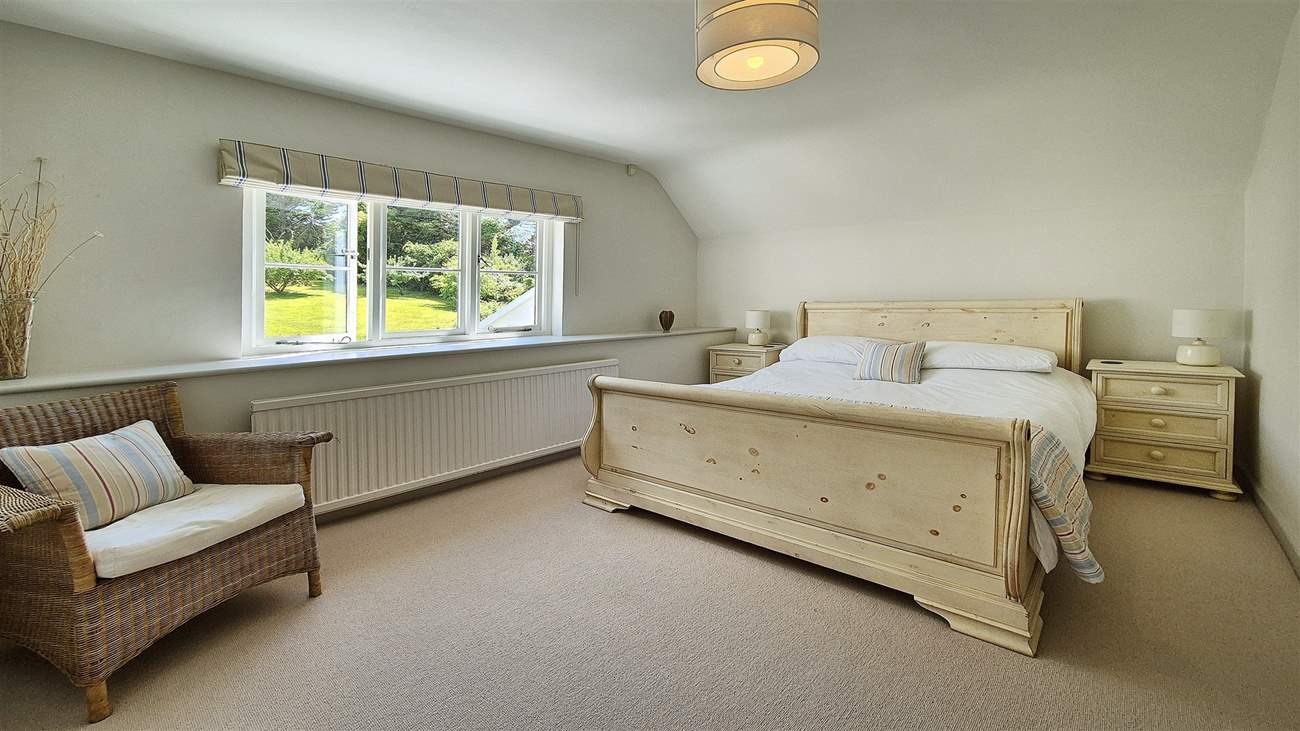 This sumptuous bedroom has a king-size bed.